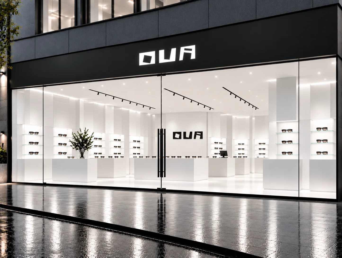 The Ova storefront at night, a white interior behind a glass facade